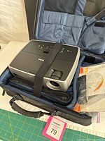 User guide booklet and software CD-ROM in clear bag alongside projector case interior