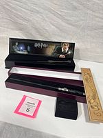 Overall lot showing both wands in their respective boxes along with sleeve and insert