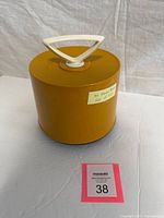 Yellow plastic record canister with lid and handle