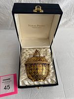 Bowl in open presentation box showing Narai Phand branding and satin lining