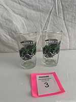 Pair of tumblers showing full graphics and overall condition