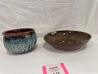 Front view of both pottery bowls showing shapes and glaze patterns