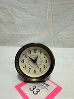 Front view showing dial, numerals and brand