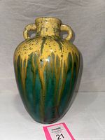 Front view of two-handled amphora vase showing drip-glaze and form