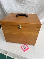 Closed oak box front view showing handle and latch