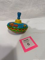 Overall view of spinning top showing animal graphics and handle