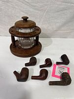 Rack, humidor jar with lid, six pipe bowls overview