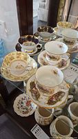 Shelf view showing multiple fine bone china teacup and saucer sets