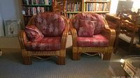 Front view of both rattan lounge chairs with cushions and pillows