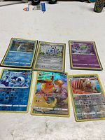 Overview of six Pokémon cards laid out on table
