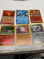All six Pokémon cards laid out on table