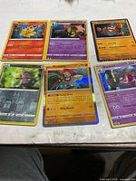 All six Pokémon cards laid out on table
