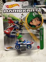 Front view of blister-packed Baby Luigi Sneeker on Mario Kart card