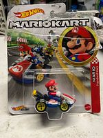 Front view of sealed Hot Wheels Mario Kart Mario car on card showing full packaging