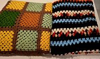 Two folded afghans side by side showing patterns and colors