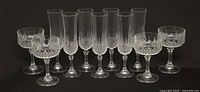 Front view showing all 11 crystal glasses, 7 flutes and 4 coupes