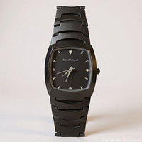 Front view of black Harvé Benard wristwatch standing upright