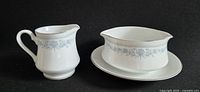 Creamer and gravy boat on underplate, showing full set