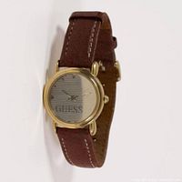 Front view of watch showing gold-tone case, striped dial, leather strap