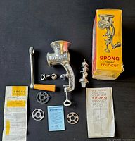 Full lot showing mincer, handle, auger, grinding plates, box, paperwork