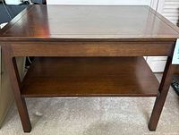 Front view of single wood side table showing top and lower shelf