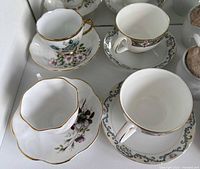 Four standard teacup & saucer sets, floral and patterned, gold trim