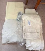 Eurotex comforter set in bag, additional folded linens, sealed hook bag visible