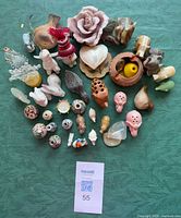 Top view of entire lot showing variety and quantity of miniature figurines and trinkets on green cloth