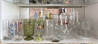 Front view of assorted glassware on shelf