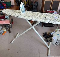 Iron resting on folding ironing board