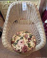 Front view of wicker chair with floral cushion