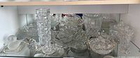 Overall view of mixed clear glass pieces on shelf