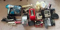 Overall view of assorted appliances, hair tools, adapters and power accessories