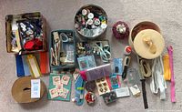 Overall view of lot with tins, boxes, zippers, trims and notions