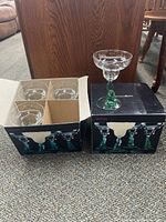 Open box showing four glass margarita stems and outer packaging