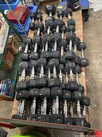 Top view of stacked rubber hex dumbbells showing multiple rows and pound markings