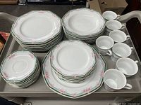 Stacked plates and teacups showing quantity and pattern