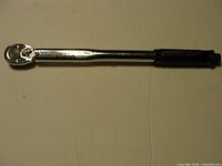 Full view of torque wrench showing ratchet head and shaft markings