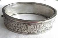 Side view showing engraved foliate pattern and clasp