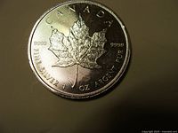 Reverse of coin showing maple leaf, purity 9999 and legends