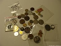 All items spread out showing variety of coins, pin, keyring, sleeves