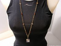 Full view of necklace on mannequin showing chain length and pendant