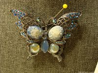 Full view of butterfly brooch showing overall design and stones