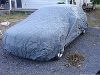 Full view of grey car cover on sedan