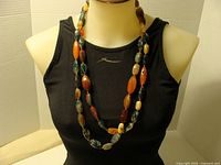 Full view of two-strand multi-coloured stone necklace on mannequin