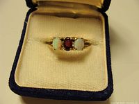 Ring in display box showing gemstone arrangement