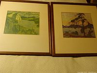 Both framed prints side by side showing frames, mats, and art