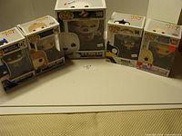 Group shot of five boxed Funko Pop! figures