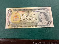 Front of 1973 Canadian one-dollar bill showing Queen Elizabeth II portrait and serial number ACH2640801
