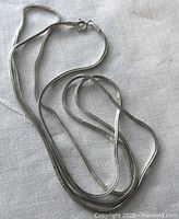 Full view of the sterling silver chain laid out showing length and link style